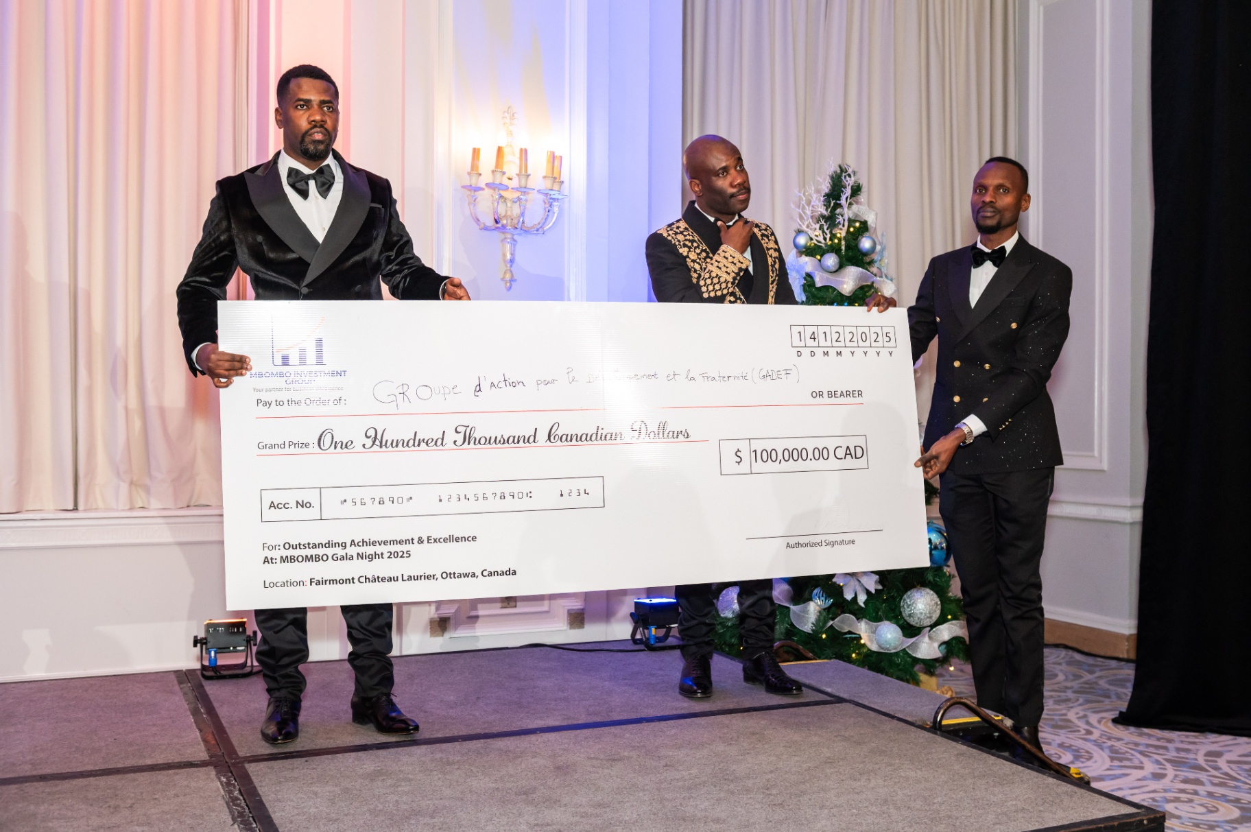 Three presenters holding the MBOMBO Gala Night 2025 grand prize cheque